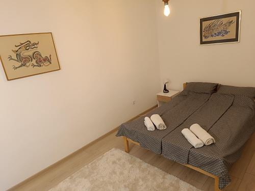 a bedroom with a bed with two pillows on it at Stan na dan - apartman Lara in Pale