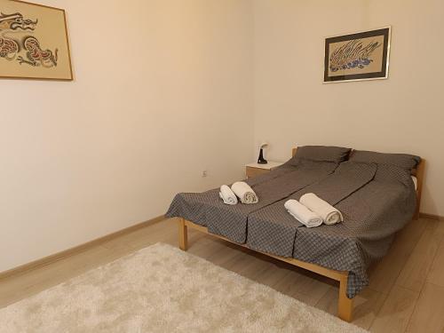 a bedroom with a bed with two pillows on it at Stan na dan - apartman Lara in Pale