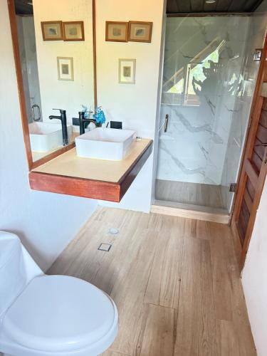 a bathroom with a sink and a mirror at Villa EL Retiro in La Luisa