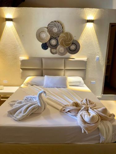 a bedroom with a bed with towels on it at Awa de Mar Playa in Tolú