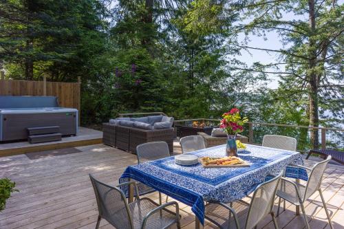 a patio with a table and chairs with pizza on it at Sandy Beachfront, Hot Tub, Pet-friendly, Kayaking 