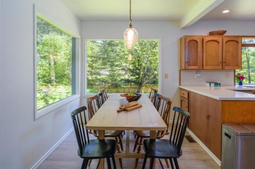 a dining room with a wooden table and chairs at Sandy Beachfront, Hot Tub, Pet-friendly, Kayaking 
