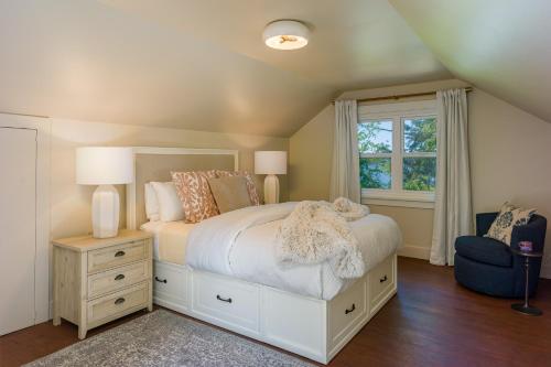 a bedroom with a white bed and a window at Sandy Beachfront, Hot Tub, Pet-friendly, Kayaking 