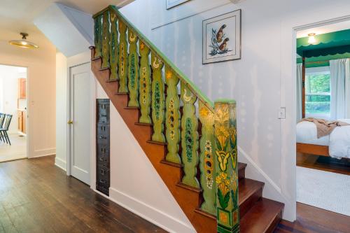 a staircase in a home with a painted stair railing at Sandy Beachfront, Hot Tub, Pet-friendly, Kayaking 