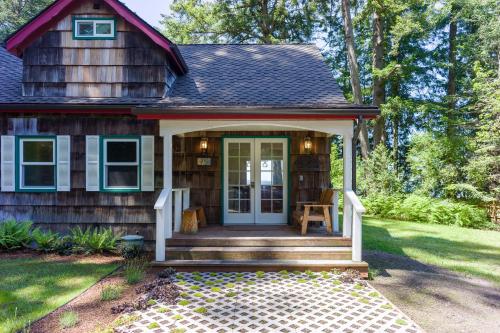 a tiny house with a porch and a door at Sandy Beachfront, Hot Tub, Pet-friendly, Kayaking 