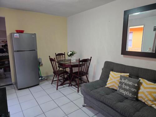 a living room with a couch and a table at Apartment bello y tranquilo in Mexico City