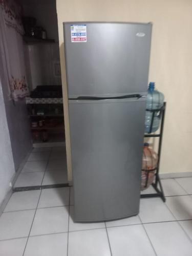 a stainless steel refrigerator in a kitchen at Apartment bello y tranquilo in Mexico City