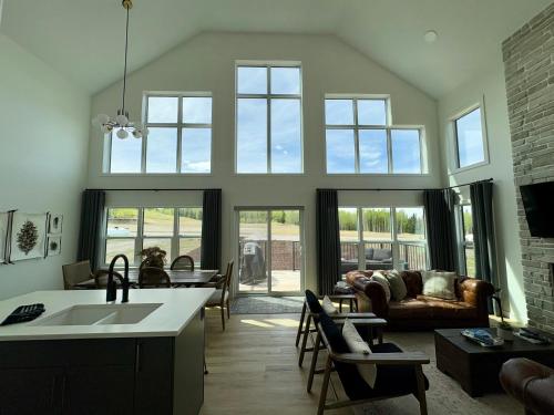 a kitchen and living room with a couch and a table at The Lamp House in Nordegg