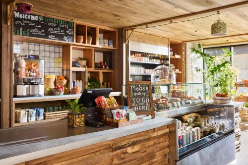 a bakery with a counter with food on it at Treehouse Hotel Silicon Valley in Sunnyvale