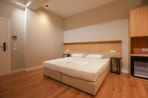 a bedroom with a large bed and a fireplace at Hotel Relax City Center in Tirana