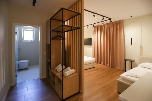 a bedroom with a room with a bed and a mirror at Hotel Relax City Center in Tirana