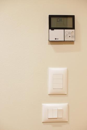 a toaster oven on a wall with two outlets at Hotel Relax City Center in Tirana