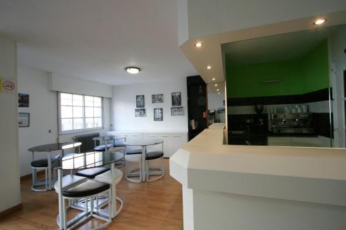 a kitchen with bar stools and a counter with a mirror at Rey Fernando in Santiago de Compostela