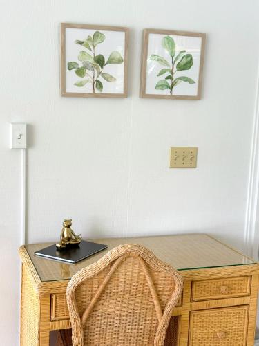 a desk with a clock on top of it and two pictures on the wall at Treetop- Timberline Terraceunit29- Four Seasons in Four Seasons
