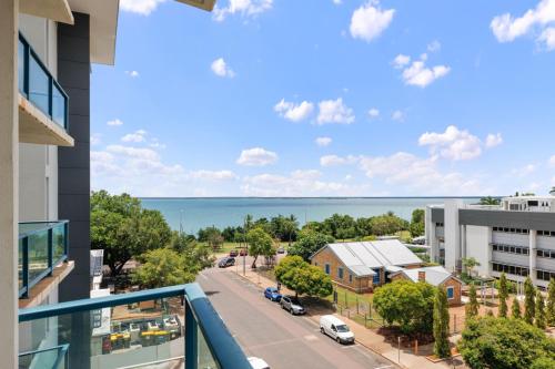 a view of the ocean from the balcony of a building at Ideal CBD Location with Harbour Views Pool Gym & BBQ in Darwin