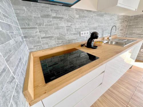 a kitchen with a sink and a counter top at Bungalow with sea view in Caleta De Fuste