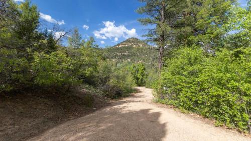 a dirt road with trees and a mountain in the background at Quiet Canyon Starry Nights HappyOurs Ranch Bunk Family Home in Glendale