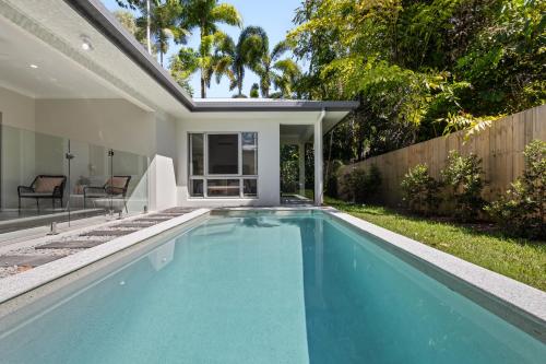 a swimming pool in the backyard of a house at St Crispins Villa 3 with private heated pool in Port Douglas