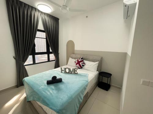 a small bedroom with a bed with a love sign on it at Central Park Damansara Near KPJ, 1Utama, The Curve by The Homez in Petaling Jaya