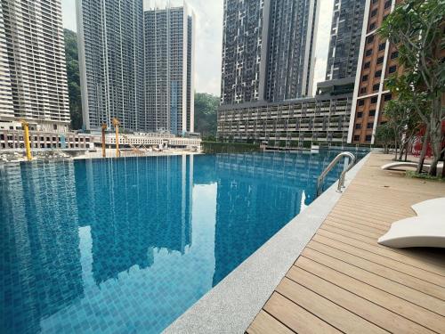 a large swimming pool in a city with tall buildings at Central Park Damansara Near KPJ, 1Utama, The Curve by The Homez in Petaling Jaya
