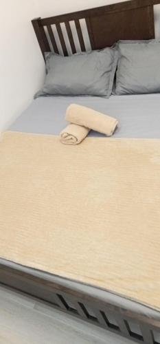a close up of a bed with a towel on it at Mi Casa Nova in Bacolod