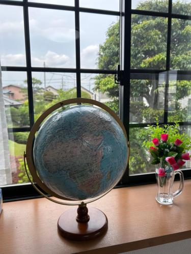 a globe sitting on a table next to a window at コンドミニアム　アガサンクス in Kuki