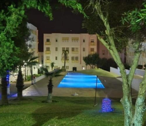 a large swimming pool in a park at night at RELAX Nouvelle ville ibn batouta Tanger in Tangier