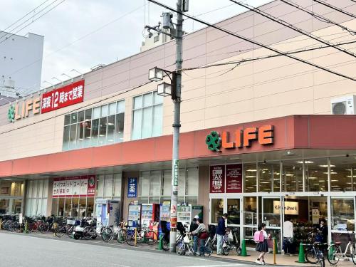 people walking in front of a store with bikes at Lucky NAMBA MINAMI in Osaka