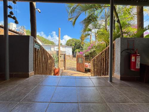 an entrance to a house with a gate and a fire hydrant at Sua Casa em Noronha - Conforto e Charme na Pousada da Iris in Fernando de Noronha