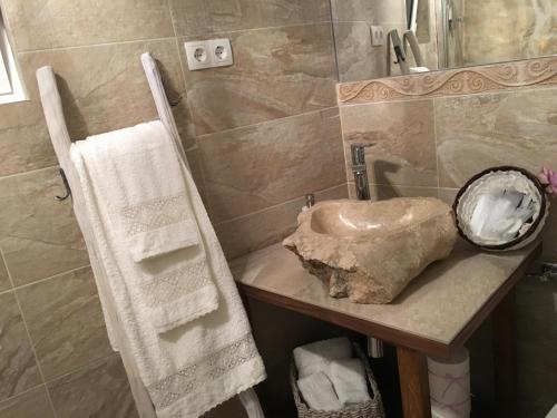 a bathroom with a sink and a rock on a counter at Casa di Lavanda in Hvar