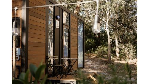 a screened in porch of a tiny house at Sunset Vine at Wonganella Estate 1 by Tiny Away in Bobs Farm