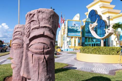 a statue of a rock head in front of a shopping center at Dolphin Cove 1 block from the Beach in Cocoa Beach
