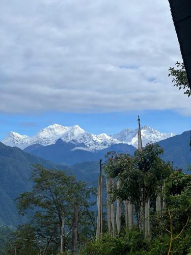 a view of a mountain range with snow covered mountains at The Blue House in Pelling