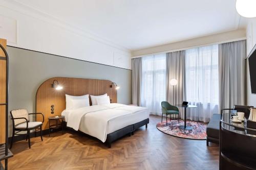 a hotel room with a bed and a desk at Hotel Astoria Vienna, Curio Collection by Hilton in Vienna