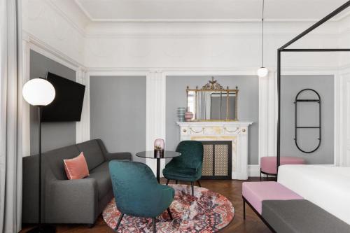 a living room with a couch and a table at Hotel Astoria Vienna, Curio Collection by Hilton in Vienna