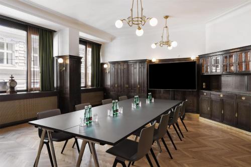 a conference room with a large table and chairs at Hotel Astoria Vienna, Curio Collection by Hilton in Vienna