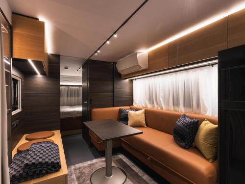 a living room with a couch and a table at Aquaignis Awaji Island TRAILER PARK in Awaji