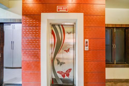 a door in a wall with butterflies on it at Super Collection O Lucknow Junction Formerly Arjun International in Lucknow
