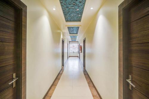 a hallway with a ceiling with a blue pattern at Super Collection O Lucknow Junction Formerly Arjun International in Lucknow