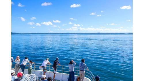a group of people on a boat in the water at Sunset Vine at Wonganella Estate 2 by Tiny Away in Bobs Farm
