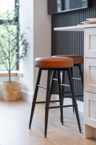 a stool in a kitchen next to a counter at The Summit Room Whistler Village in Whistler