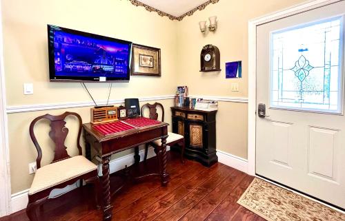 a room with a desk and a tv on the wall at Barker House 3# Suite-heart of oldtown in Niagara on the Lake