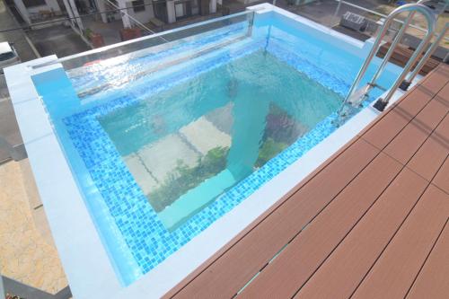 a swimming pool with a chair in it at at60percent in Miyako-jima