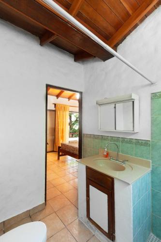 a bathroom with a sink and a toilet in a room at Casa Majahualt in San Juan del Sur