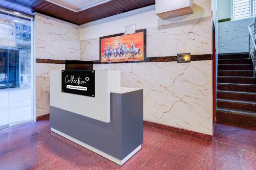 a lobby with stairs and a sign on a wall at Super Collection O ITPL Bangalore in Bengaluru