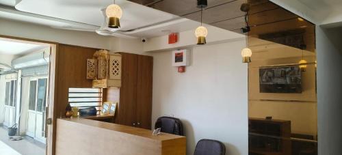 a office with a desk and chairs in a room at The Gravity Hotel in Ahmedabad