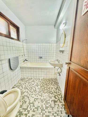 a bathroom with a toilet and a sink at Liu Xu Homestay in Tainan
