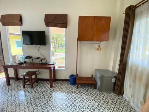 a room with a desk and a computer and a window at Park & Pool Resort in Nong Khai