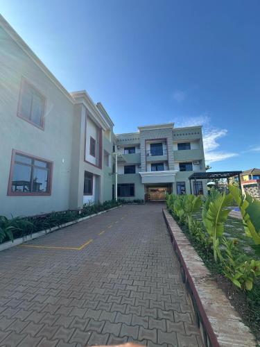 a cobblestone street in front of a building at Entebbe Serenity breeze apartments in Entebbe