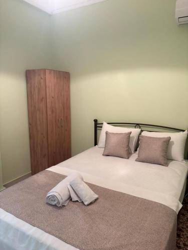a bedroom with a bed with a towel on the floor at SMYRNA HOMES CHiOS ERATO in Chios